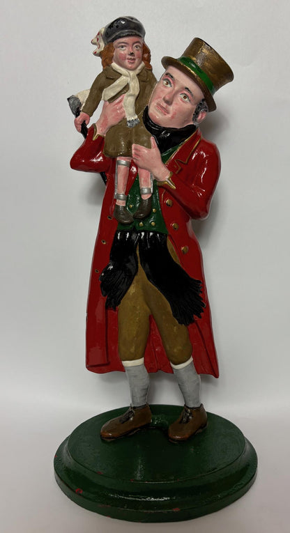 Early 20th‑century cast‑iron doorstop of Bob Cratchit & Tiny Tim from Dickens’ A Christmas Carol.